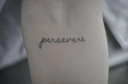 Tattoo inscription on the arm