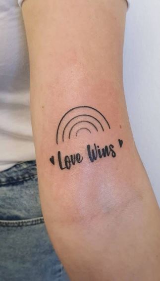 Tattoo with the inscription Love wins