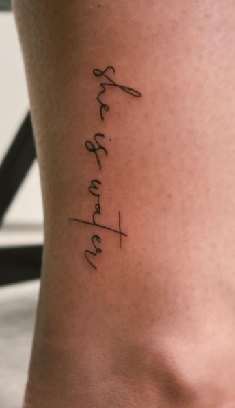 Tattoo with the inscription "She is water