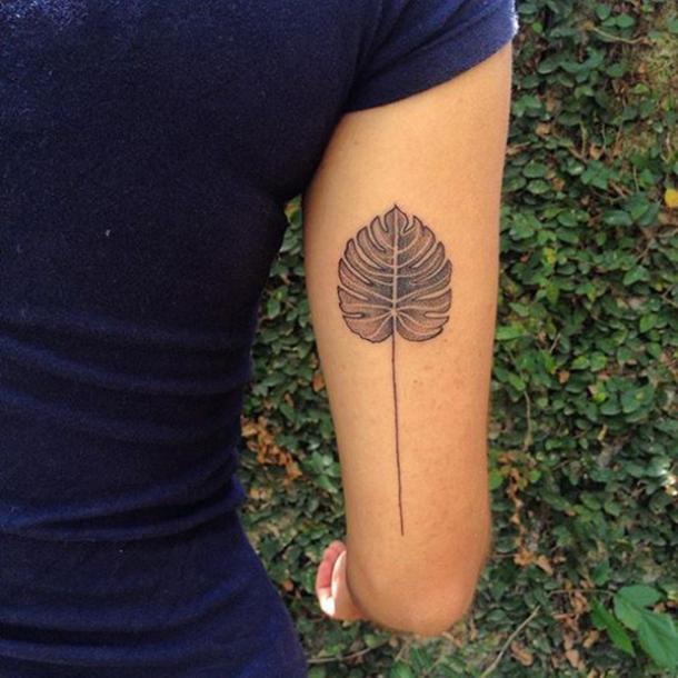  Tattoo leaf in the form of dots with a thin stem.