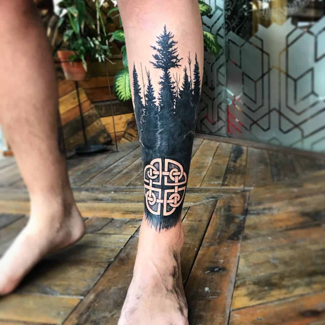 Scandinavian forest-inspired tattoos featuring a tree