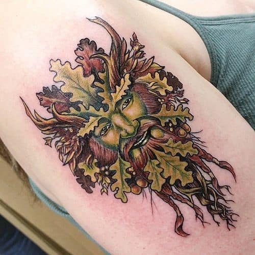 Gorgeous colorful tattoo of a Viking symbol above the shoulder