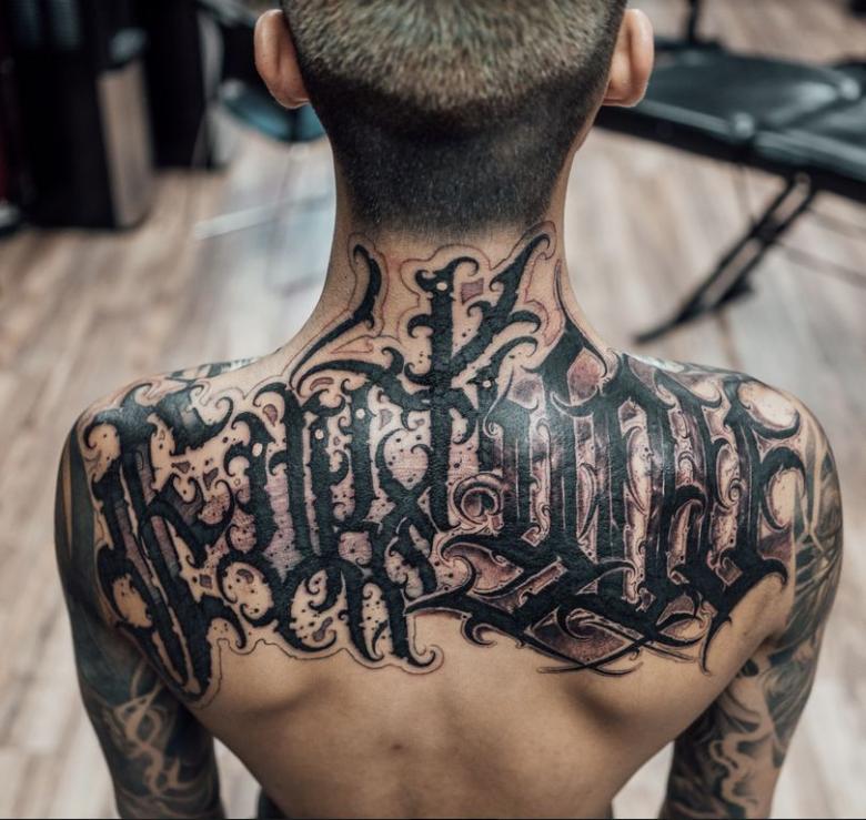 Calligraphy tattoo on the back