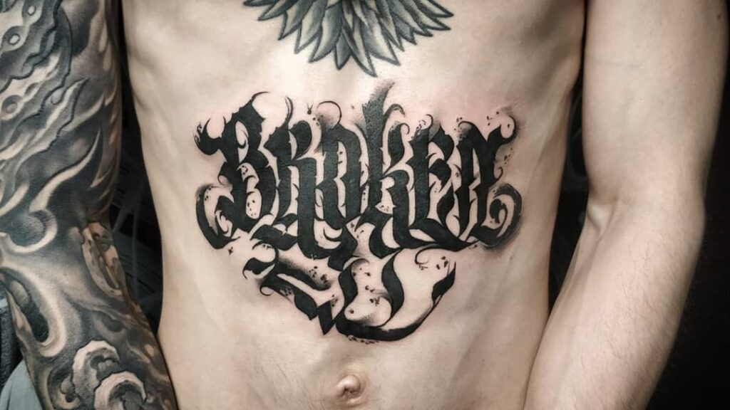 Calligraphy style tattoo on the belly