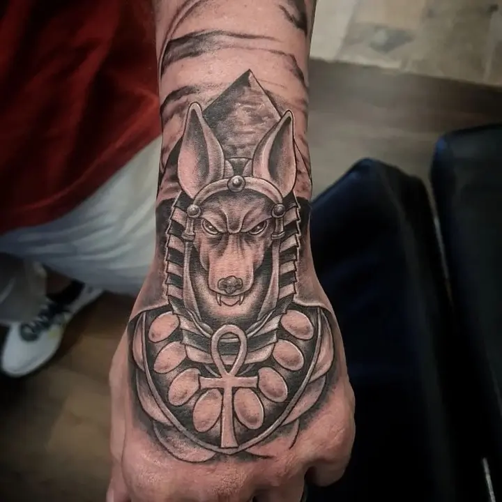 Anubis tattoo on his arm