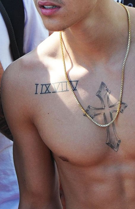 Tattoo of a cross on the chest