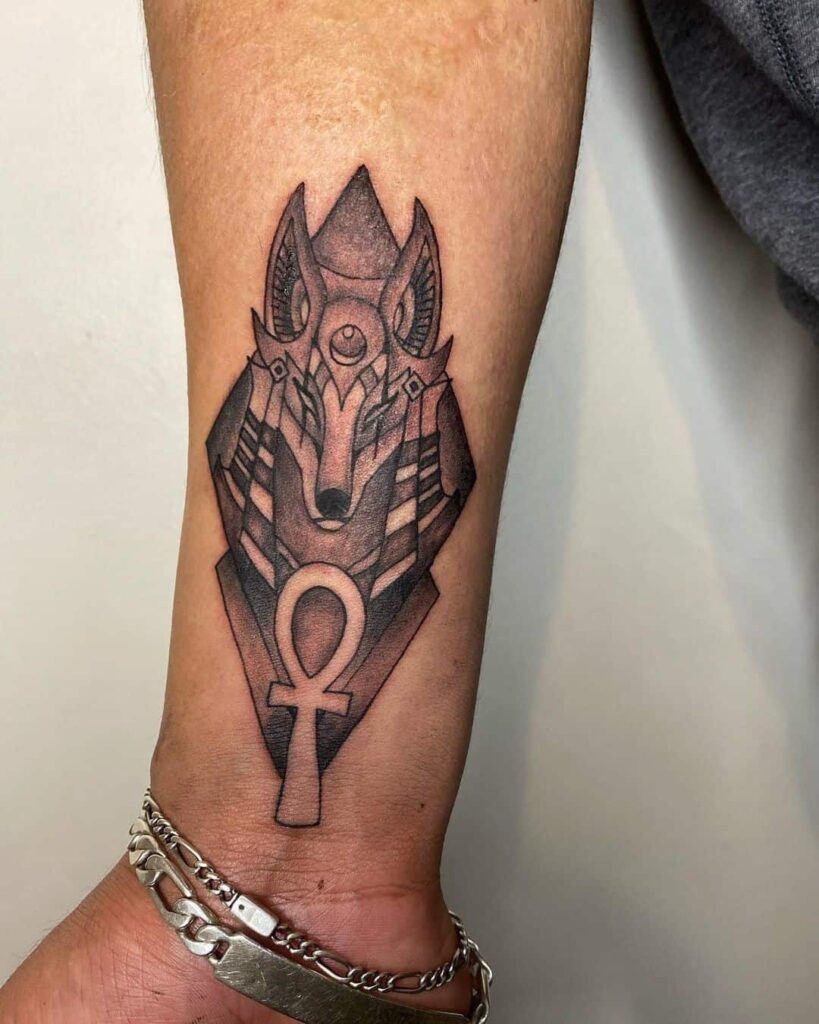 Egyptian tattoo of Anubis in black ink