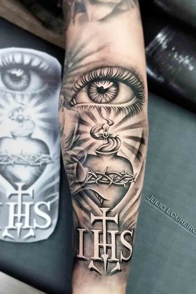 Religious tattoo of the cross on the arm