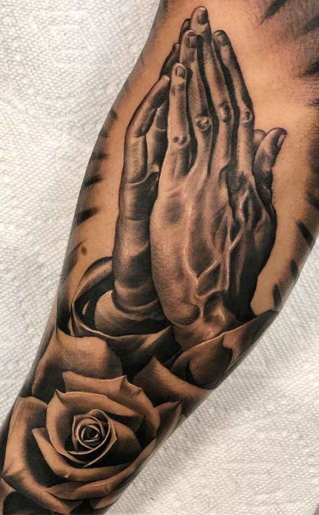 Religious tattoo of the praying hand