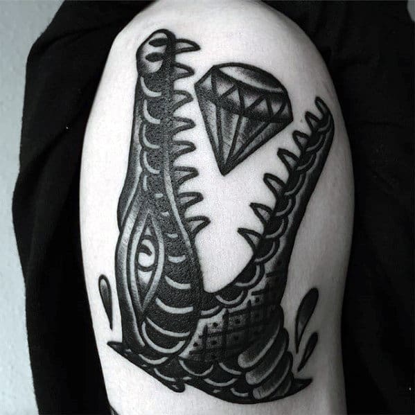 Crocodile tattoo with a diamond on the shoulder