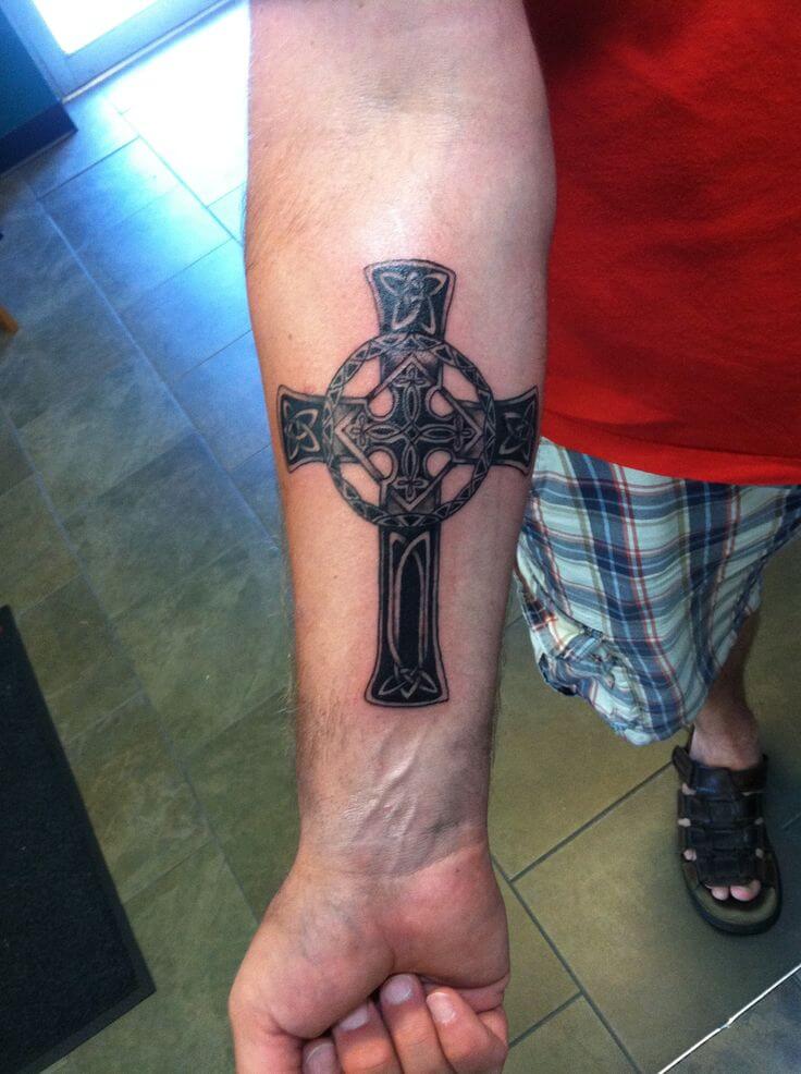 Tattoo of a cross on your arm