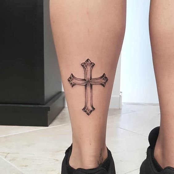 Tattoo of the cross on the leg