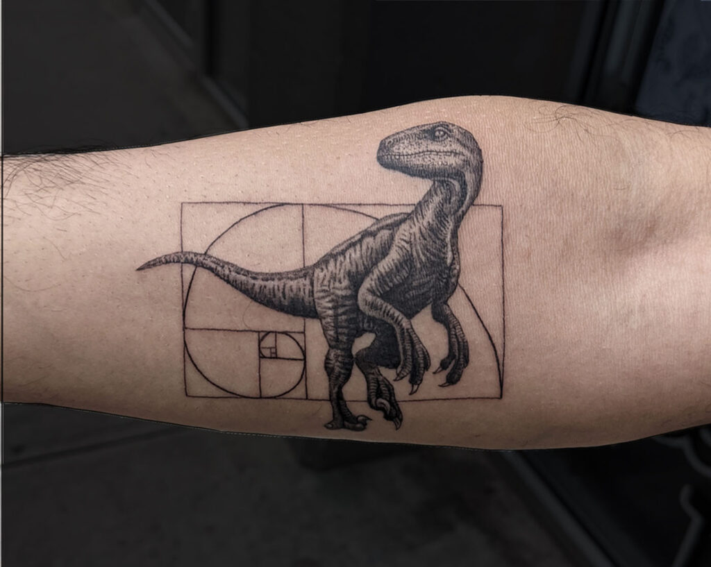 Realistic dinosaur tattoo on the forearm