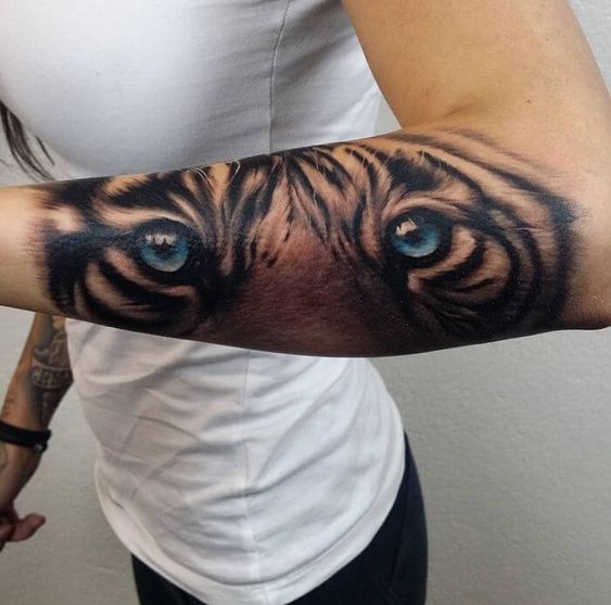 Realistic tiger eye tattoo on the forearm