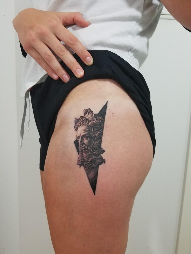 Tattoo of the god Poseidon on the thigh