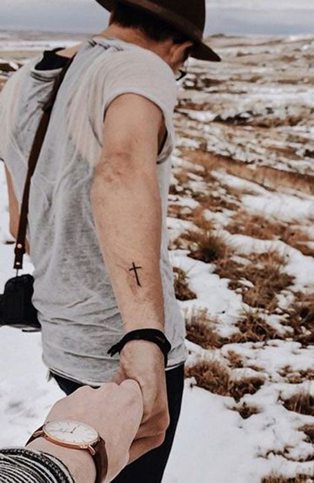 Cross tattoo on forearm