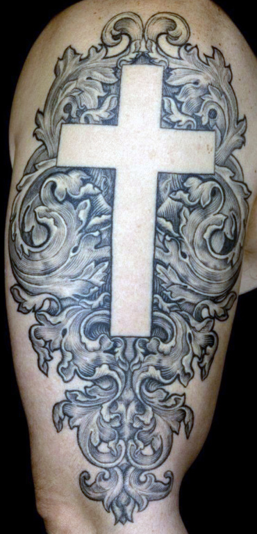 Cross tattoo on the shoulder