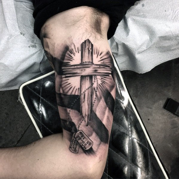 Cross tattoo on the shoulder