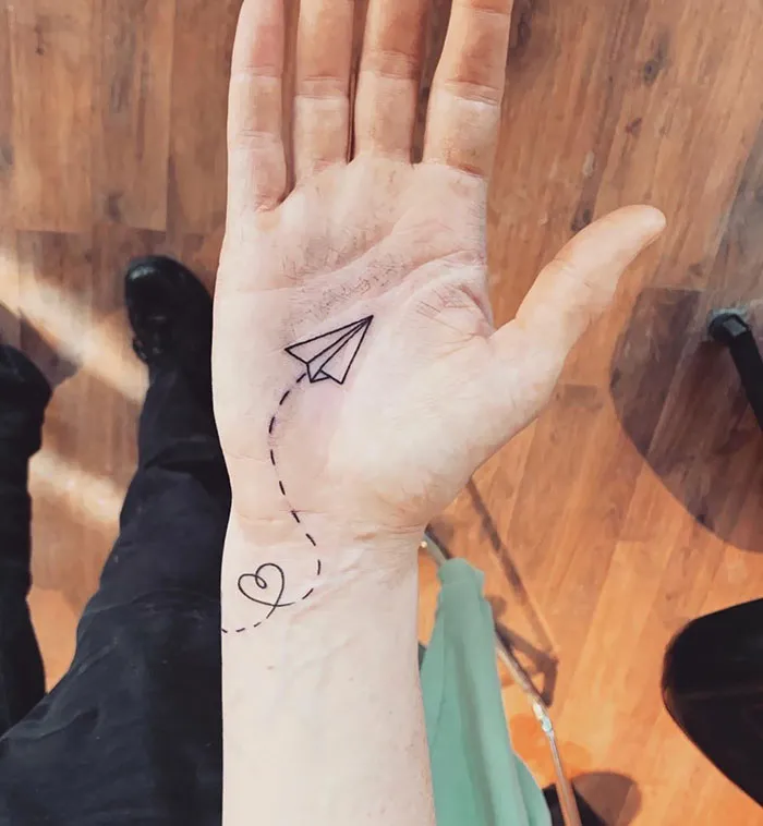 Minimalist tattoo on the palm