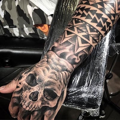 Tattoo with a skull on the wrist