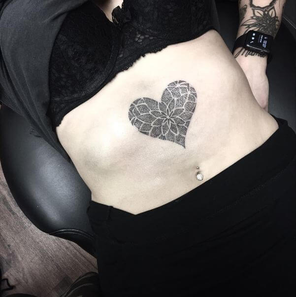 Tattoo of a heart on the abdomen