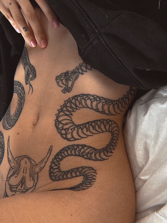 Snake tattoo on the abdomen