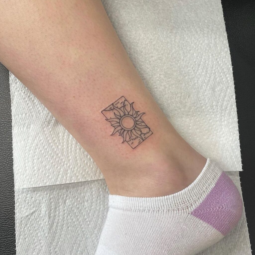 Sun tattoo on the ankle