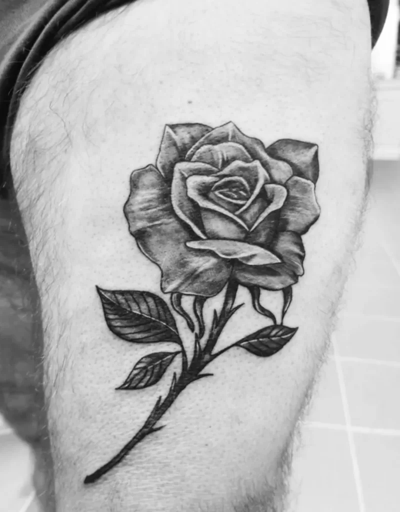 Tattoo of a rose on the thigh