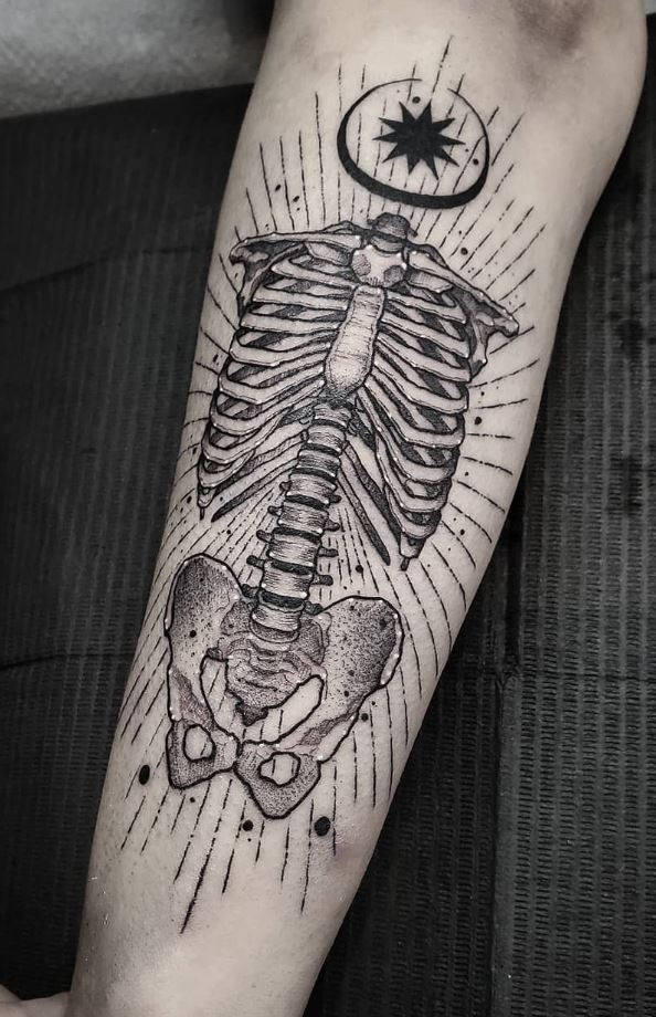 Black and gray skeleton tattoo on forearm