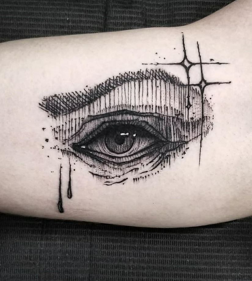 Black and gray eye tattoo on the arm