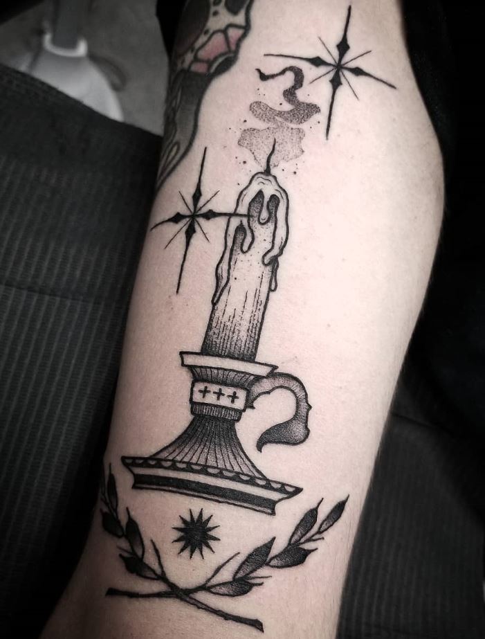 black and gray tattoo on the forearm