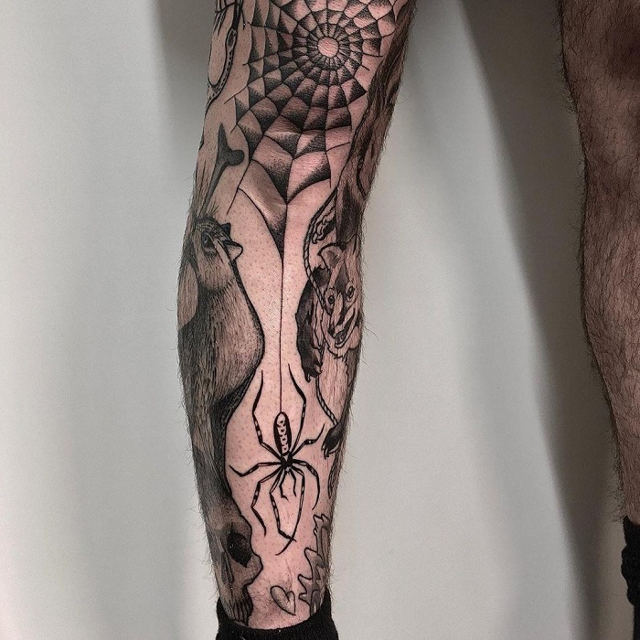 Tattoo of a spider web and spider on the shin