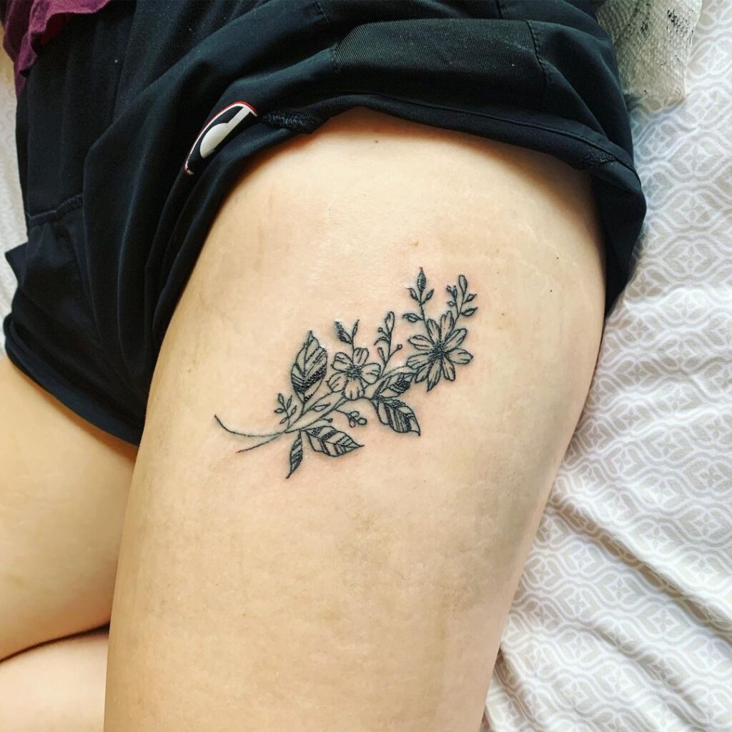 Minimalist floral tattoos on the hip