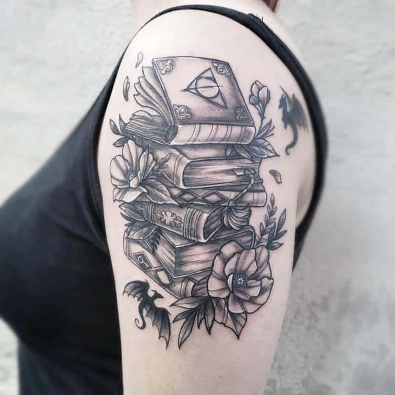 Book tattoo on biceps