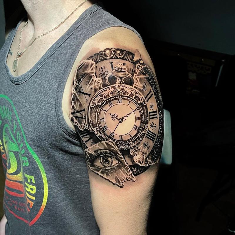 Tattoo of a watch on the biceps