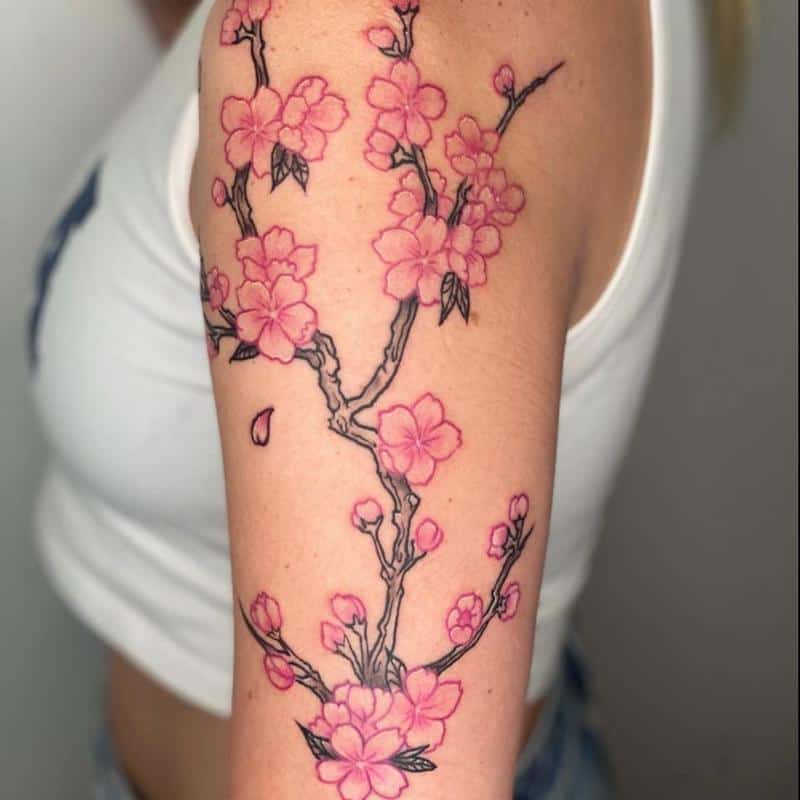 Tattoo of a sakura on the bicep of a girl