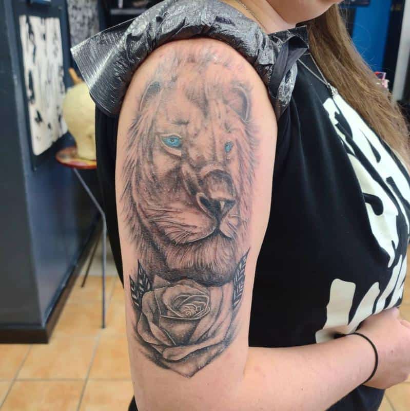 A tattoo of a lion on the biceps