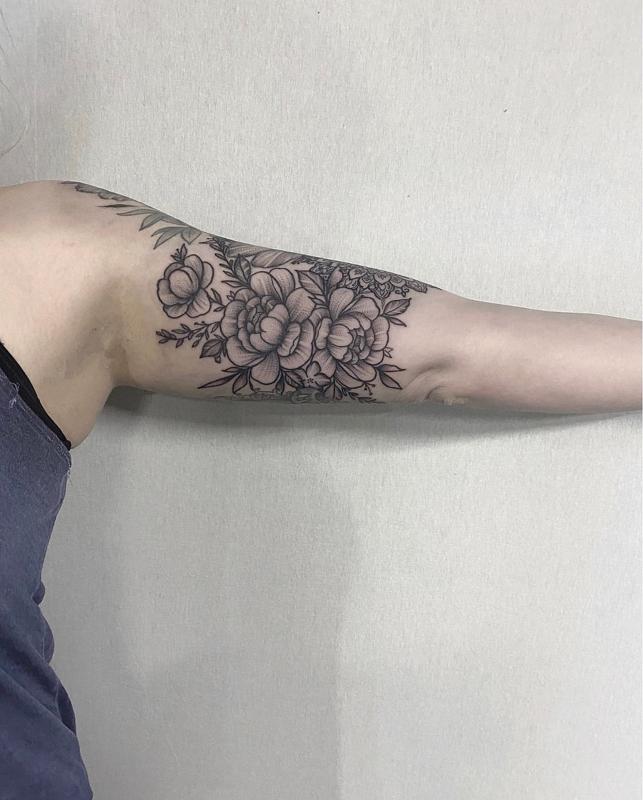 Flower tattoo on the bicep