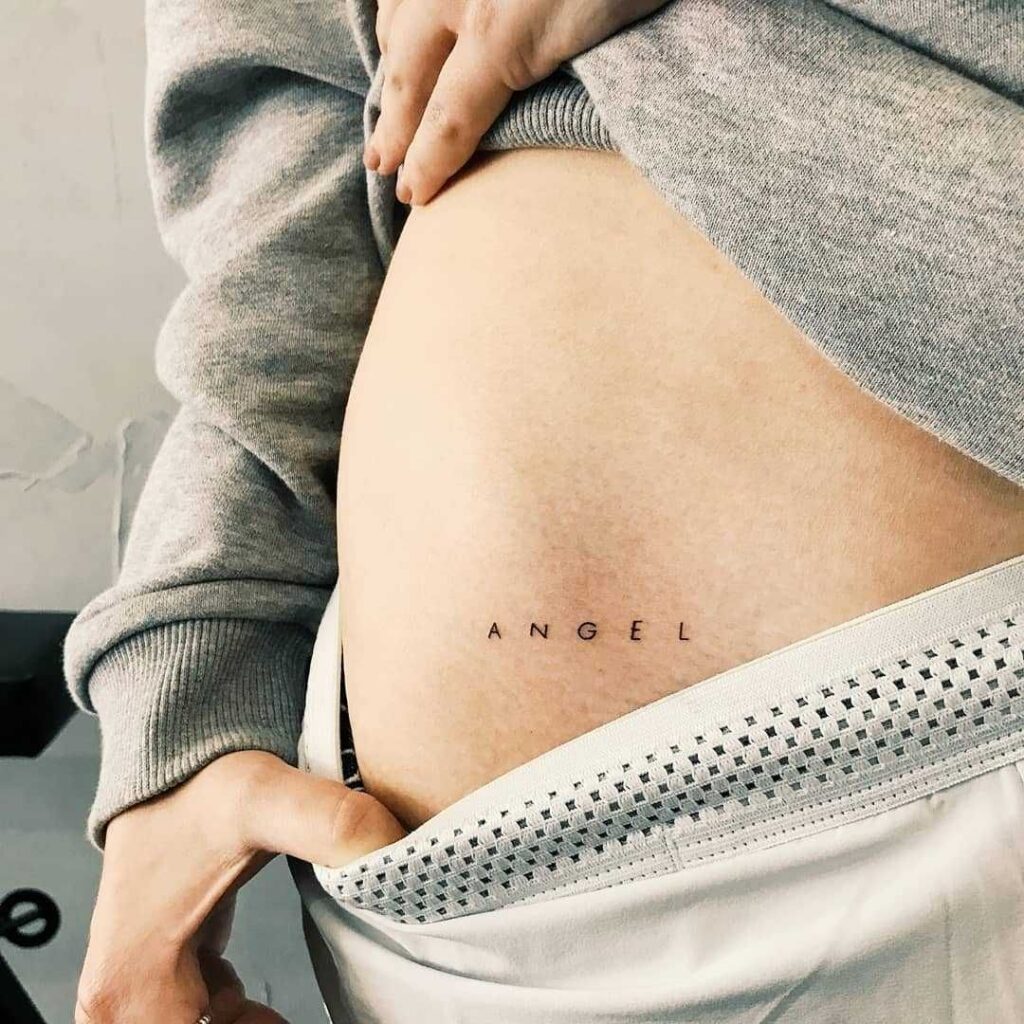 Tattoo word on the hip minimalism