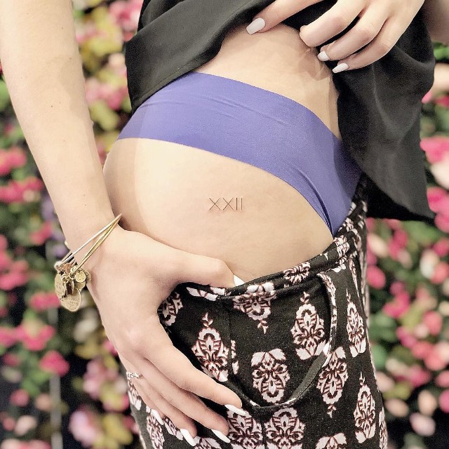 Tattoo Roman numerals on the hip