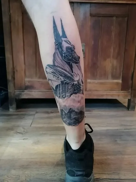 Tattoo of Anubis on his leg