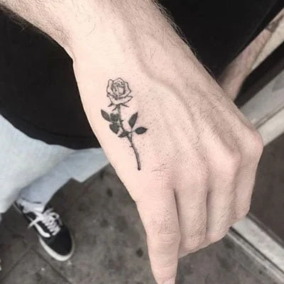 A small rose tattoo on the brush