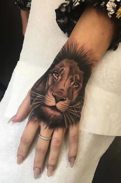 Tattoo of a lion on the hand