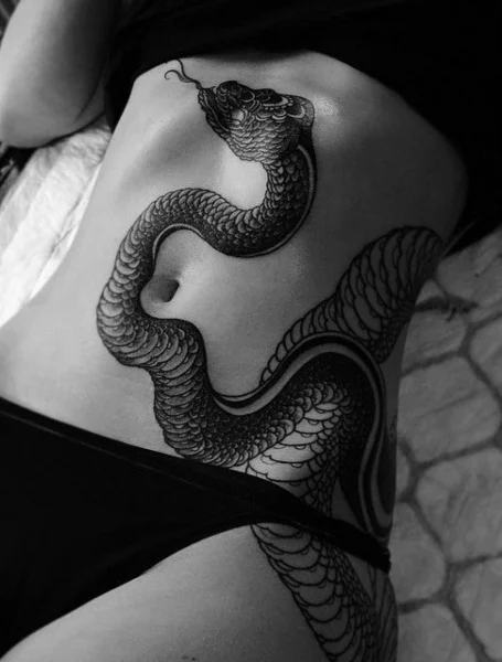 Snake tattoo on a woman's stomach