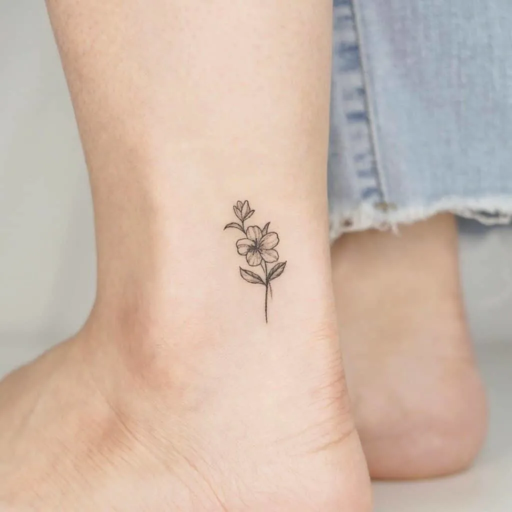 Tattoo of a flower on the ankle