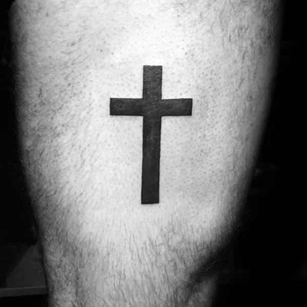 Cross tattoo on the hip