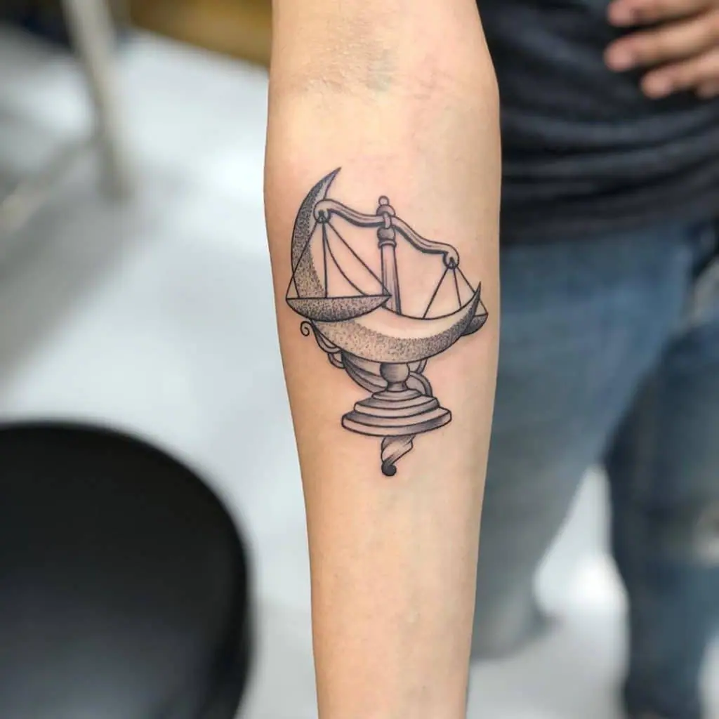 Libra zodiac sign tattoo on the forearm