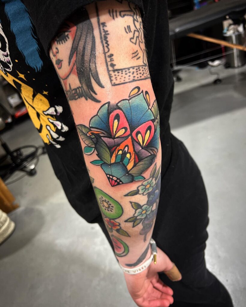 Fun pastel flower tattoo on the elbow