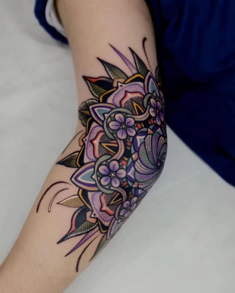 Colored tattoo of flowers on the elbow