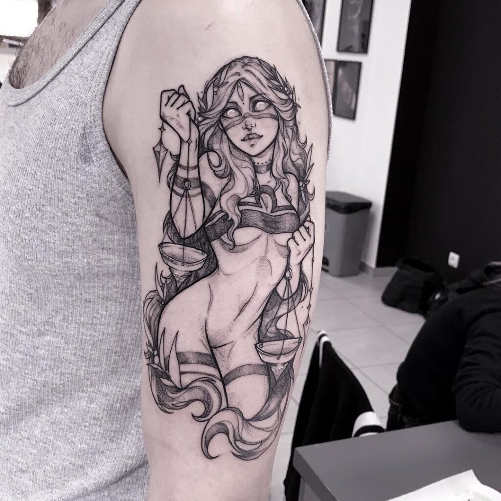 Tattoo of a Libra sign and a girl on the shoulder